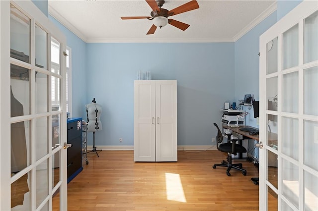 office featuring french doors, light wood-type flooring, crown molding, ceiling fan, and baseboards