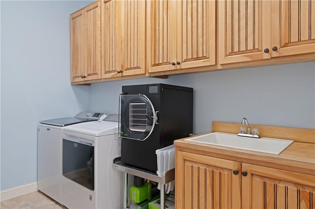 washroom featuring cabinet space and washer and clothes dryer