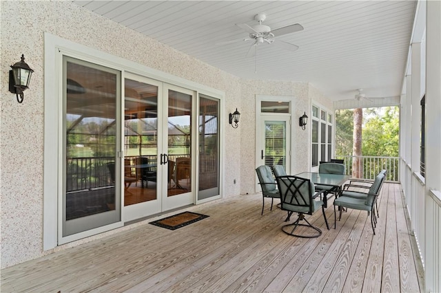 sunroom with a ceiling fan, french doors, wood finished floors, and wallpapered walls