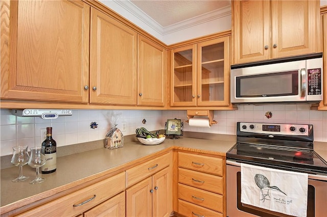 kitchen with tasteful backsplash, stainless steel appliances, and ornamental molding