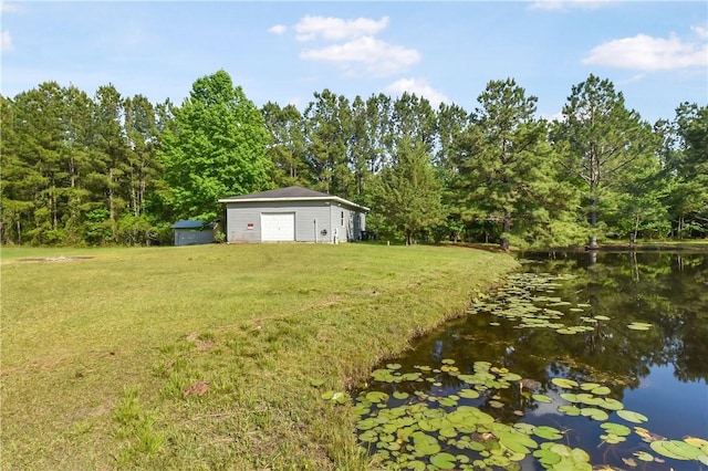 view of yard featuring an outbuilding and a water view