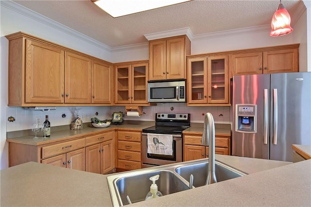 kitchen featuring tasteful backsplash, stainless steel appliances, hanging light fixtures, and ornamental molding