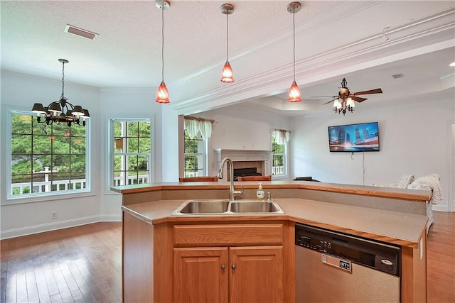 kitchen featuring dishwasher, sink, hardwood / wood-style floors, a textured ceiling, and a center island with sink