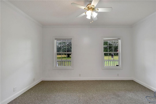 unfurnished room featuring carpet floors, a wealth of natural light, ornamental molding, and ceiling fan