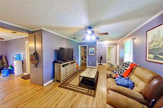 315 Magnolia St, Waycross, GA 31501 - living room featuring a textured ceiling, ornamental molding, a ceiling fan, and light wood finished floors