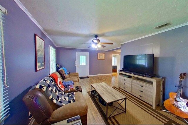 315 Magnolia St, Waycross, GA 31501 - living area featuring a ceiling fan, wood finished floors, a textured ceiling, and visible vents