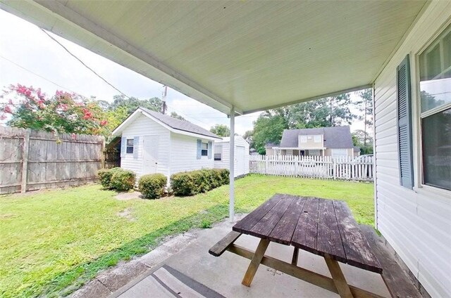 315 Magnolia St, Waycross, GA 31501 - view of patio / terrace with an outbuilding, a fenced backyard, and a storage shed