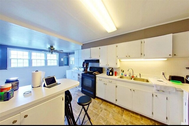 315 Magnolia St, Waycross, GA 31501 - kitchen with white cabinetry, black range with electric cooktop, light countertops, and a sink
