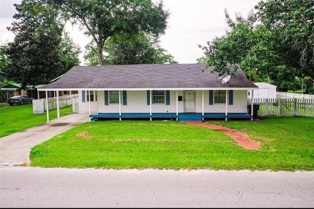 315 Magnolia St, Waycross, GA 31501 - view of front of house featuring fence, driveway, a front yard, covered porch, and a carport