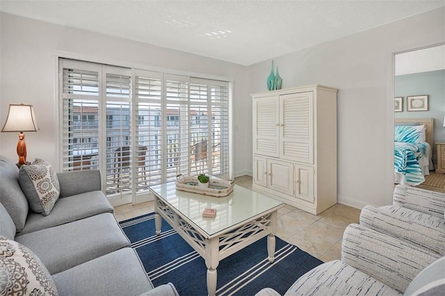 living room featuring light tile patterned floors and a textured ceiling