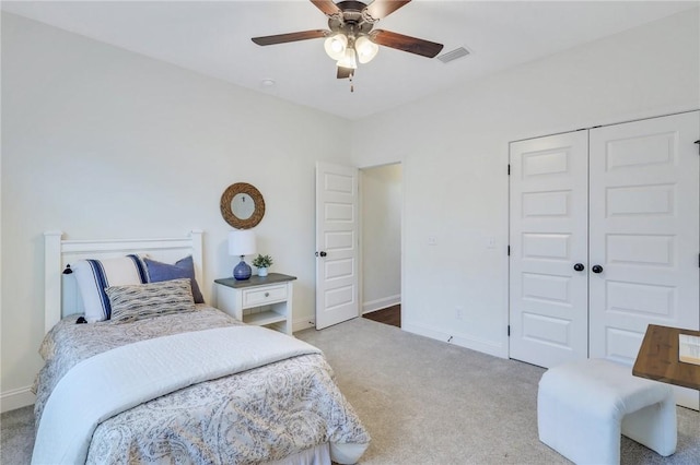 bedroom with ceiling fan, carpet floors, and a closet