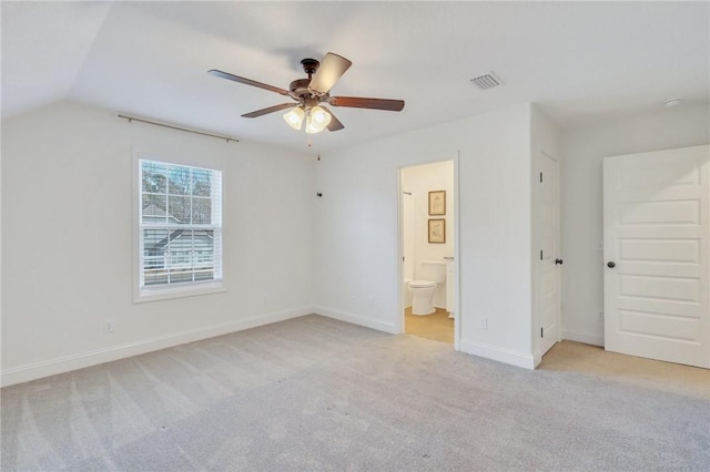 unfurnished bedroom with ceiling fan, lofted ceiling, connected bathroom, and light carpet