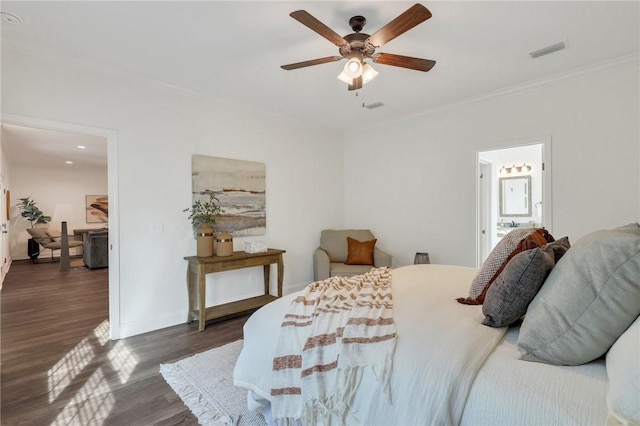 bedroom with dark hardwood / wood-style flooring, ornamental molding, ceiling fan, and ensuite bath