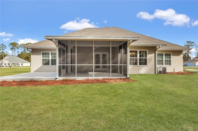 rear view of property with a sunroom, a yard, cooling unit, and a patio area