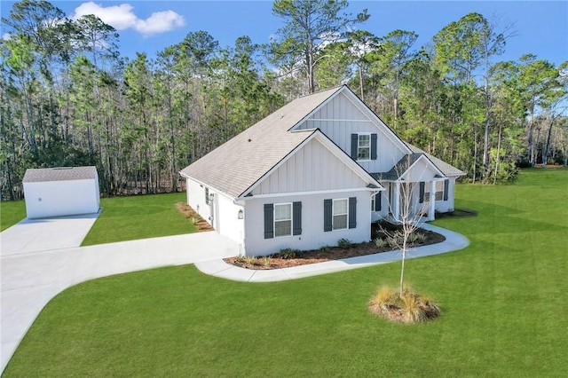 view of front of home with an outbuilding and a front lawn