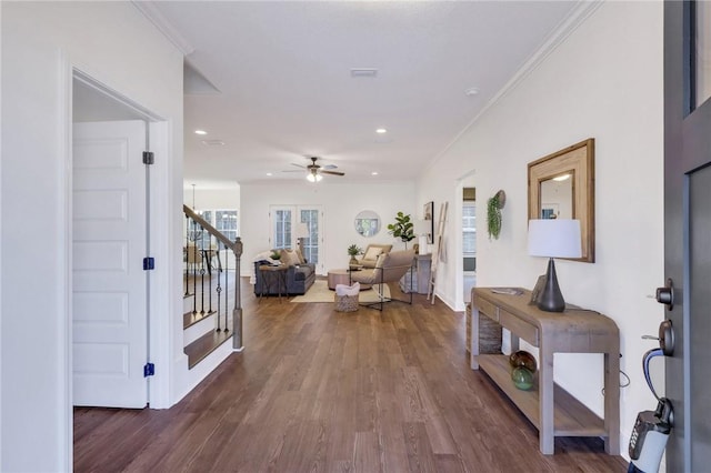 hall featuring ornamental molding and dark hardwood / wood-style flooring