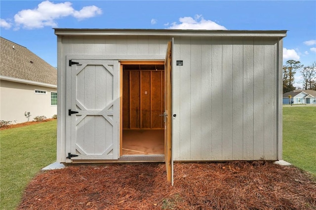 view of outbuilding with a lawn