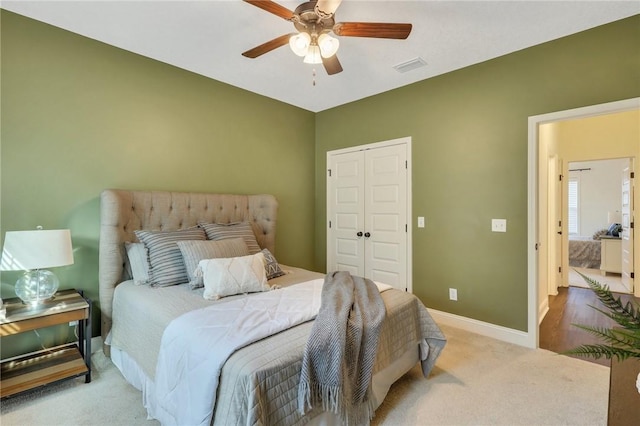 carpeted bedroom featuring a closet and ceiling fan