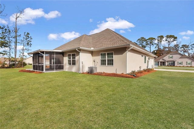 back of property featuring central AC, a lawn, and a sunroom