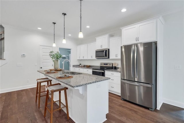 kitchen featuring sink, white cabinetry, a center island with sink, stainless steel appliances, and light stone countertops