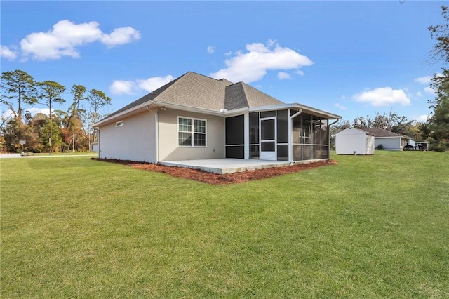 back of house featuring a sunroom, a yard, a shed, and a patio area