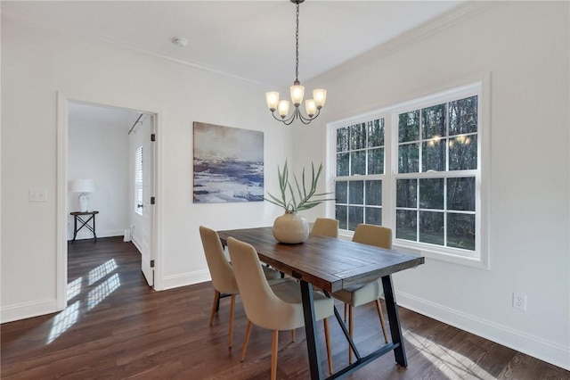 dining area with plenty of natural light, dark hardwood / wood-style flooring, and a notable chandelier