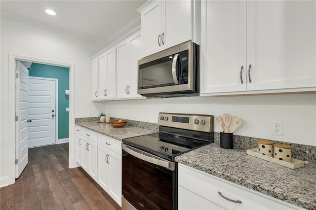 kitchen with white cabinets, stainless steel appliances, crown molding, light stone countertops, and dark wood-type flooring