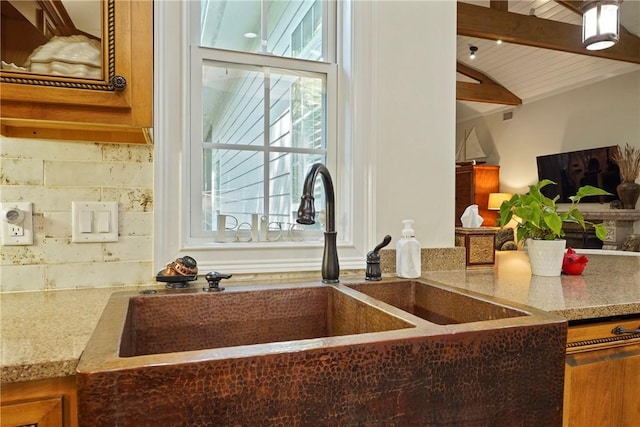 219 Abbott Ln, Saint Simons Island, GA 31522 - kitchen with light stone counters, brown cabinets, and wooden ceiling