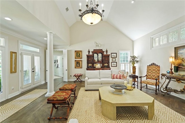 219 Abbott Ln, Saint Simons Island, GA 31522 - living area featuring ornate columns, healthy amount of natural light, high vaulted ceiling, a chandelier, and dark wood-style floors