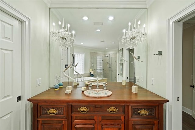 219 Abbott Ln, Saint Simons Island, GA 31522 - bathroom featuring a stall shower, a chandelier, ornamental molding, a freestanding tub, and recessed lighting