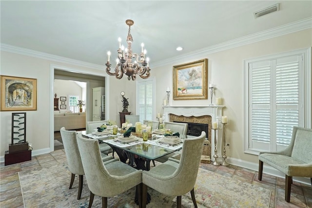 219 Abbott Ln, Saint Simons Island, GA 31522 - dining space featuring a chandelier, ornamental molding, and a fireplace