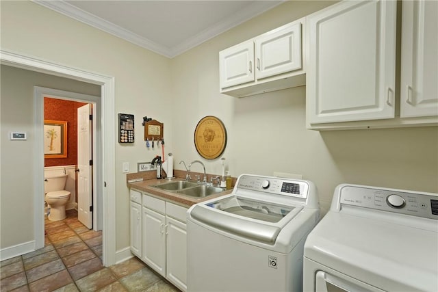 219 Abbott Ln, Saint Simons Island, GA 31522 - washroom with separate washer and dryer, cabinet space, crown molding, and stone finish flooring