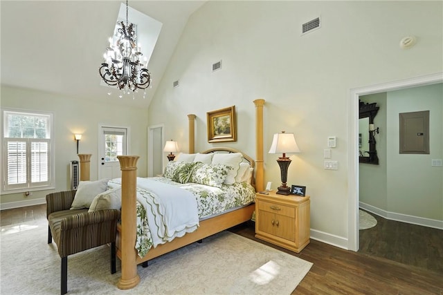 219 Abbott Ln, Saint Simons Island, GA 31522 - bedroom with electric panel, a chandelier, high vaulted ceiling, and wood finished floors