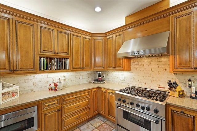 219 Abbott Ln, Saint Simons Island, GA 31522 - kitchen featuring stainless steel appliances, wall chimney range hood, and decorative backsplash