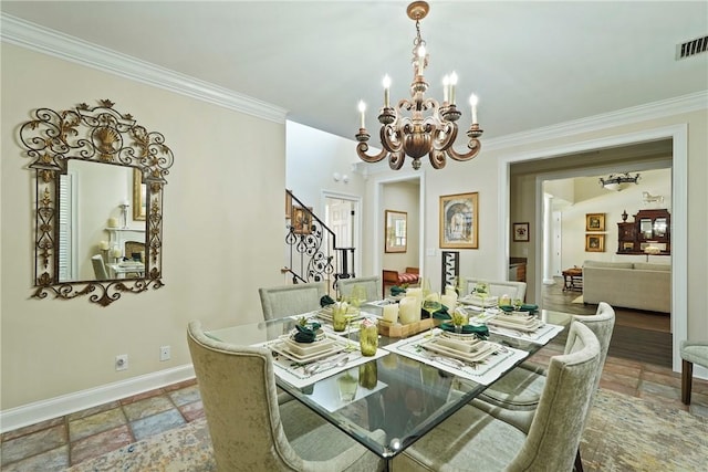 219 Abbott Ln, Saint Simons Island, GA 31522 - dining space featuring a chandelier, stairway, stone tile floors, and crown molding