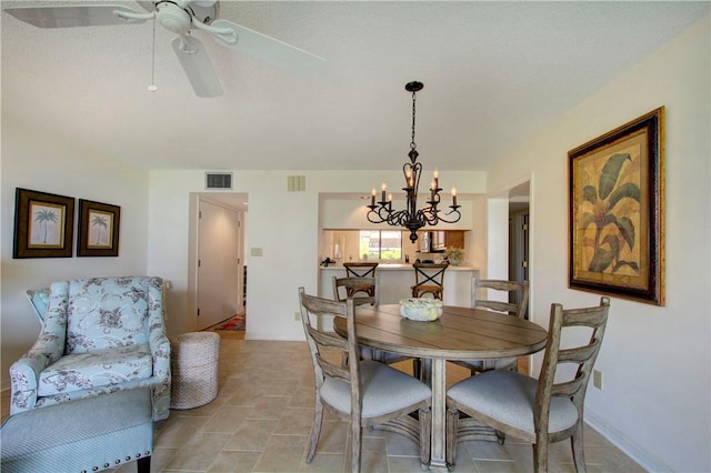 dining room with ceiling fan with notable chandelier