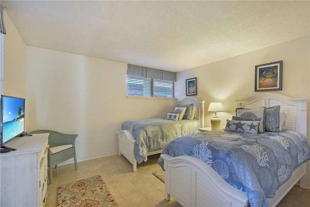 tiled bedroom featuring a textured ceiling