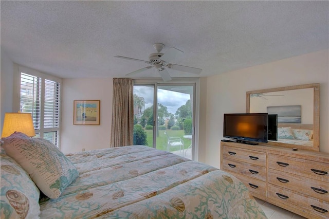 tiled bedroom featuring access to exterior, a textured ceiling, and ceiling fan