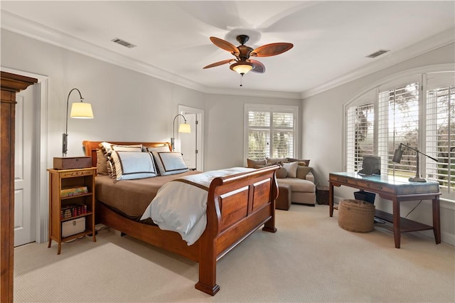 carpeted bedroom featuring ceiling fan and ornamental molding