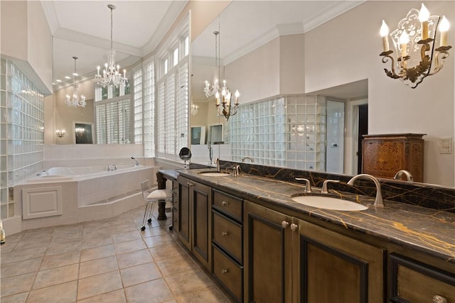 bathroom featuring tile patterned floors, a relaxing tiled tub, ornamental molding, and vanity