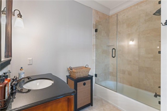 bathroom with tile patterned floors, vanity, and combined bath / shower with glass door