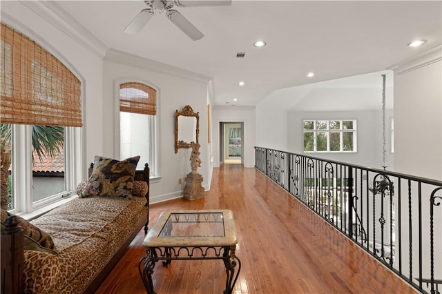 sitting room featuring ceiling fan, light hardwood / wood-style flooring, and ornamental molding