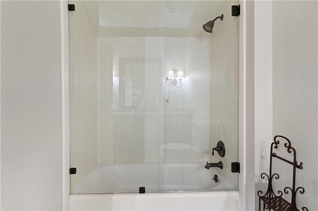 bathroom with shower / bath combination with glass door