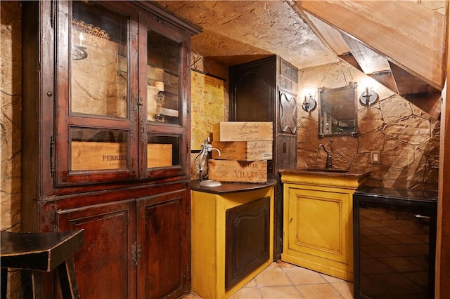 bar with sink and light tile patterned floors