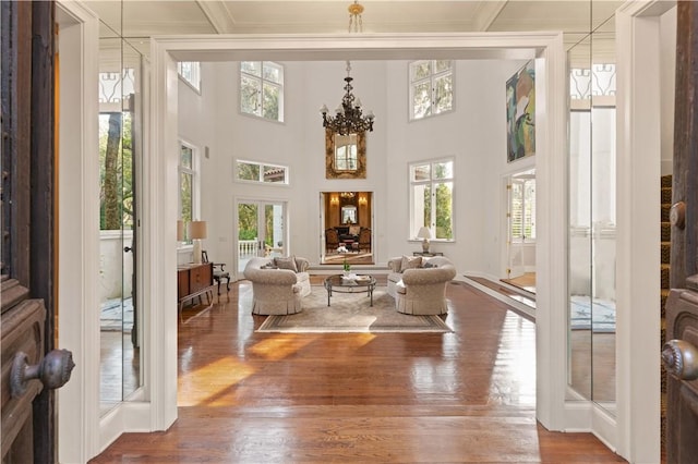 sunroom / solarium featuring a wealth of natural light and an inviting chandelier