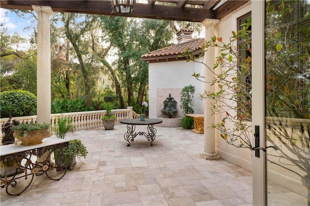 view of patio / terrace featuring exterior fireplace