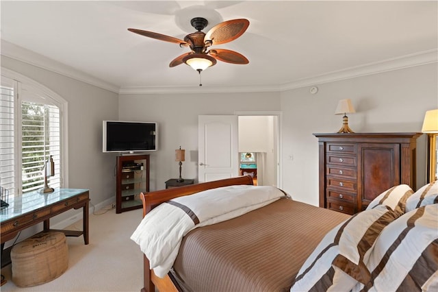 carpeted bedroom featuring ceiling fan and crown molding