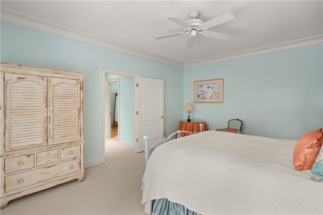 bedroom featuring ceiling fan, crown molding, and light carpet