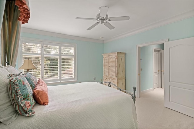 carpeted bedroom with ceiling fan and ornamental molding