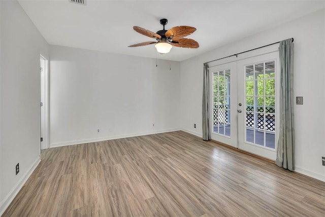 spare room with ceiling fan, french doors, and light hardwood / wood-style floors